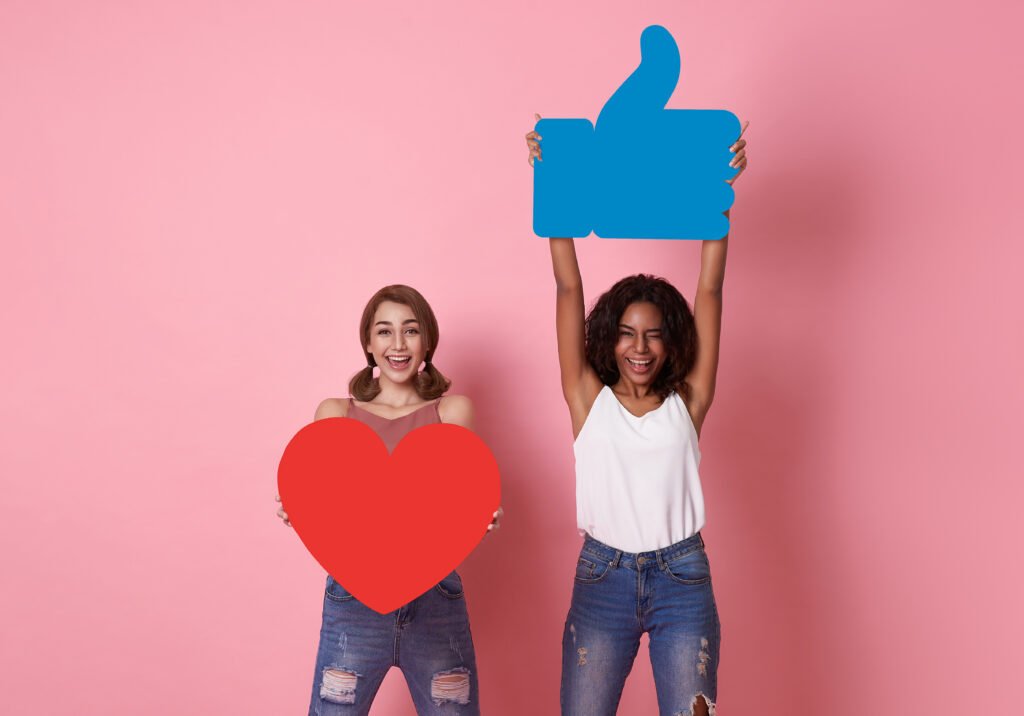 cheerful woman holding up emojis for social media marketing