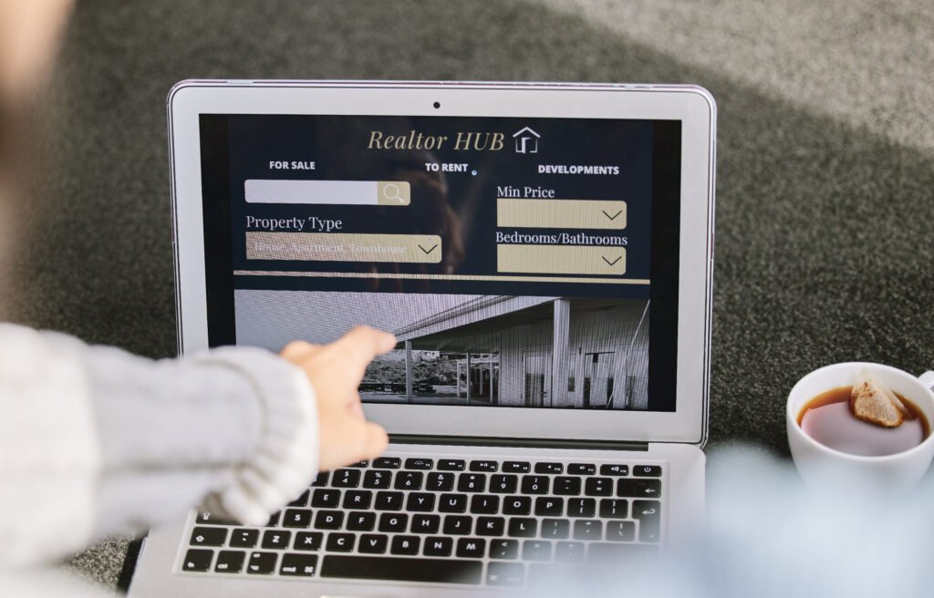 Cropped shot of a realtor woman sitting and searching for new properties on her laptop.