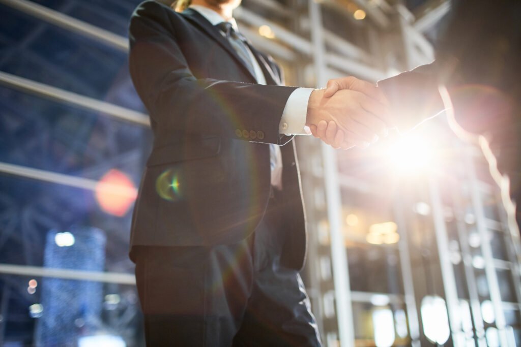 Handshake of two big successful investors