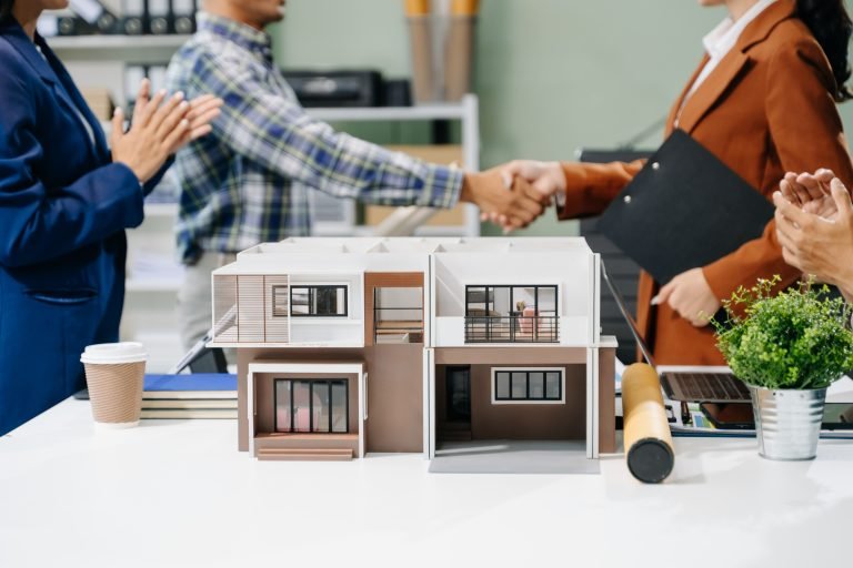 Explore a modern architectural office meeting with Asian professionals designing innovative buildings. Keywords: architects, design, collaboration, office, modern, building, teamwork