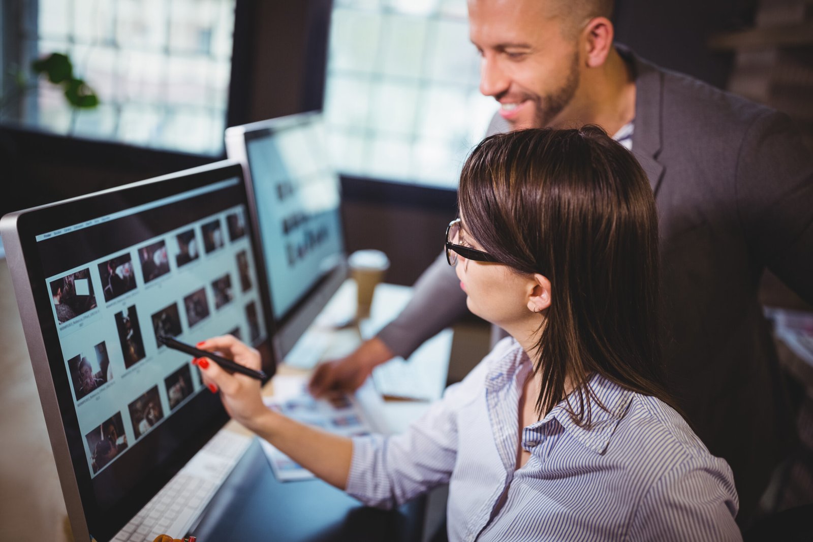 Webmasters working together on a computer to create content for a website