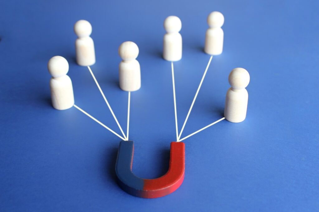 Magnet attracts employee candidates dolls. Hiring staff. Find best talent, Human resources concept
