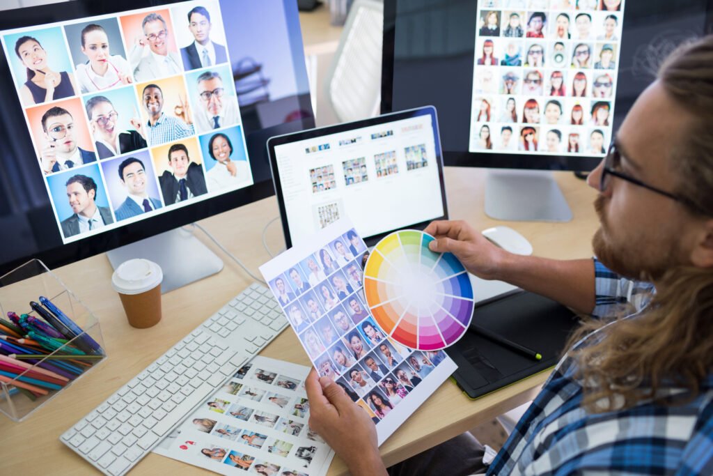 Male executive working at his desk in office designing a custom realtor website design