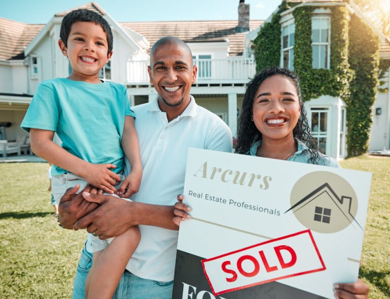 Happy family posing with a realtor who just helped them sell their home