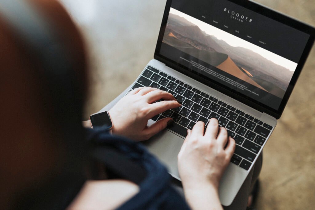 woman working on a computer and putting together her realtor website