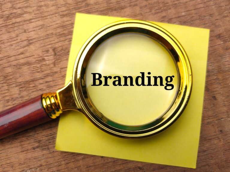 a magnifying glass above a branding sticky note for a realtor website